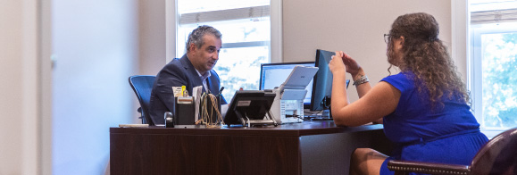 a man and woman sitting at a desk