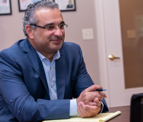 a man sitting at a desk while smiling